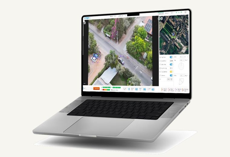 FlightOps camera view tracking vehicles with detection boxes, shown on a laptop