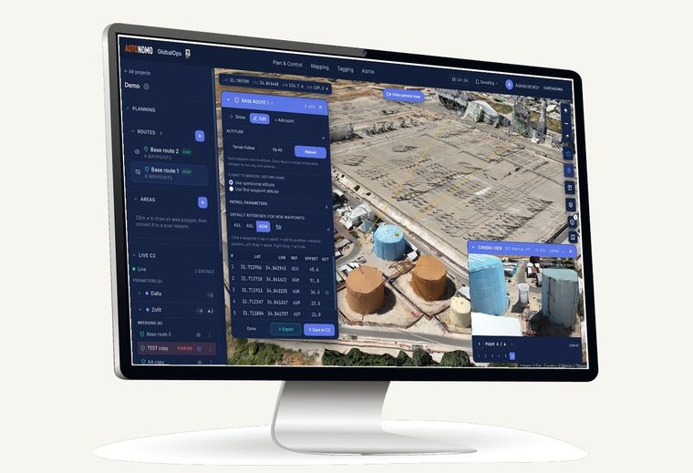 GlobalOps route planning over a 3D site model, shown on a desktop monitor